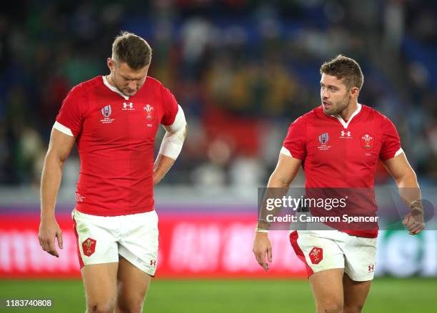 Leigh Halfpenny and Dan Biggar of Wales react as they walk off the pitch following the Rugby World Cup 2019 Semi-Final match between Wales and South...