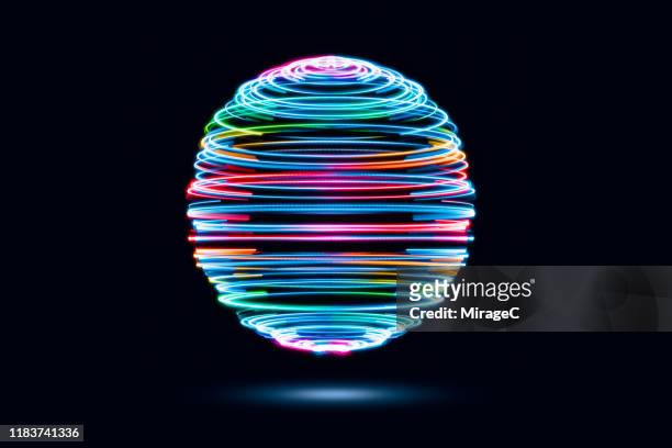 spinning iridescent light trails sphere - lichtspur stock-fotos und bilder