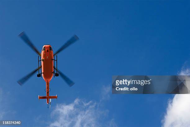 rescue helicopter - low angle view - low flying aircraft stockfoto's en -beelden