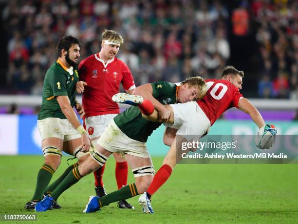 Wales' Dan Biggar is tackled by South Africa's Pieter-Steph du Toit during the Rugby World Cup 2019 Semi-Final match between Wales and South Africa...