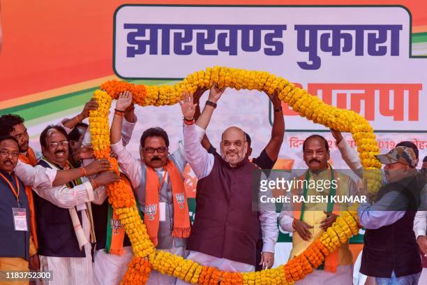 Union Home Minister and Bharatiya Janata Party National President Amit Shah along with Jharkhand Chief Minister Raghubar Das is being garlanded...