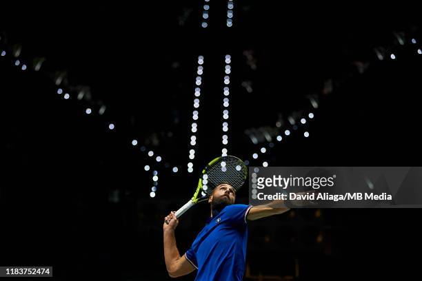 Benoit Paire of France serves during his match against Novak Djokovic of Serbia during Day Four of the 2019 Davis Cup at La Caja Magica on November...