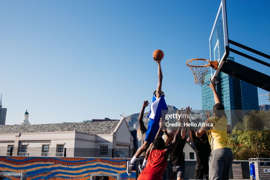 Tall player floating in to score a basket