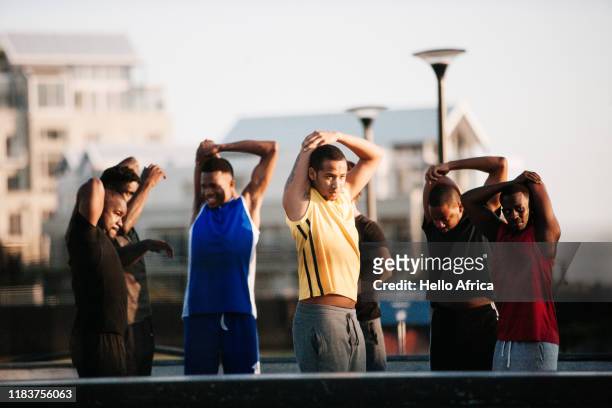 Group of athletes stretching flanks and arms