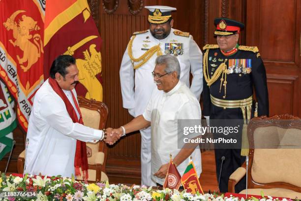 Sri Lanka's newly appointed prime minister Mahinda Rajapaksa is greeted by his brother, Sri Lanka's newly elected President Gotabaya Rajapaksa, at...