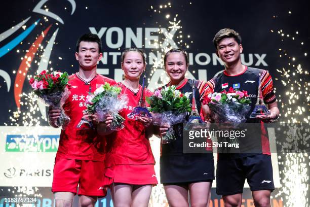 Zheng Siwei and Huang Yaqiong of China and Melati Daeva Oktavianti and Praveen Jordan of Indonesia pose with their trophies after the Mixed Double...