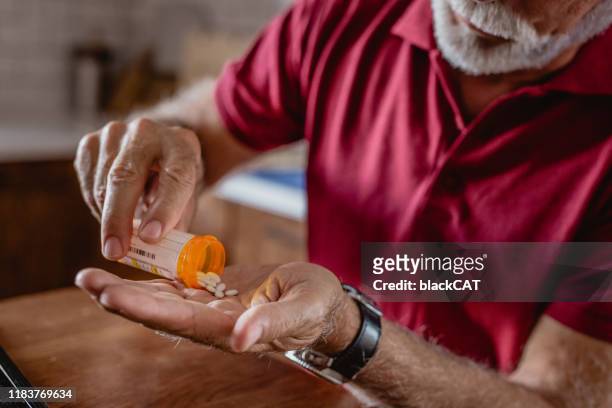 taking a pill at home - prescription medicine stock pictures, royalty-free photos & images