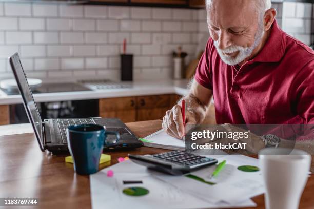 senior man is planning a home budget - retirement advice stock pictures, royalty-free photos & images