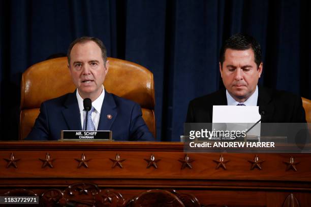 House Intelligence Committee chair, Adam Schiff speaks as Ranking Member Devin Nunes looks at a report on the Russian interference in the 2016...