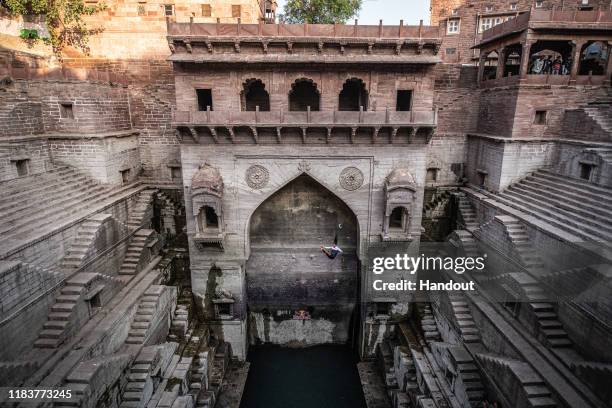 In this handout image provided by Red Bull, Orlando Duque of Colombia, dives at the Toorji Ka Jhalra stepwell during an off-season Red Bull Cliff...