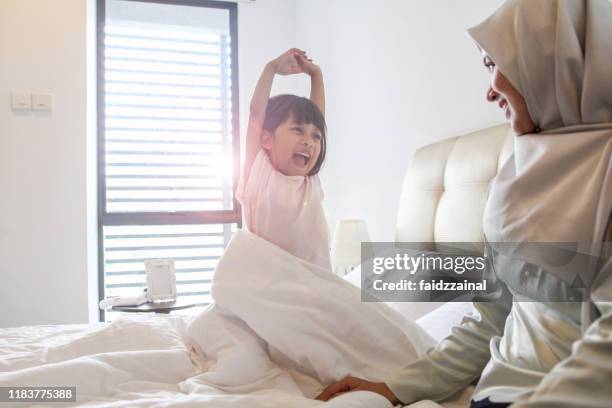 a little girl wakes up and being playful - malay culture stock pictures, royalty-free photos & images