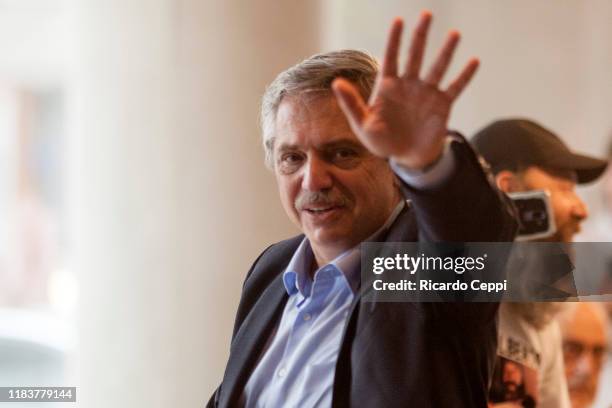 Presidential candidate Alberto Fernandez of 'Frente de Todos' greets supporters at a Starbucks coffee shop in Puerto Madero after voting during the...