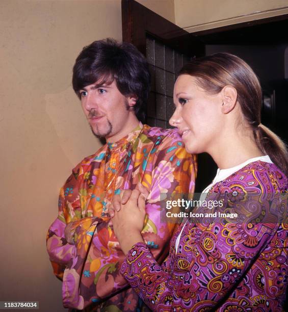 British-American singer-songwriter, musician, member of The Hollies and Crosby, Stills & Nash, Graham Nash, poses with a friend while wearing a...