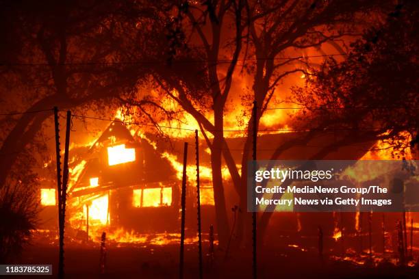 Structure on Highway 128 goes up in flames after the Kincade Fire raged into the Alexander Valley, Sunday morning, Oct. 27 east of Geyserville, Calif.