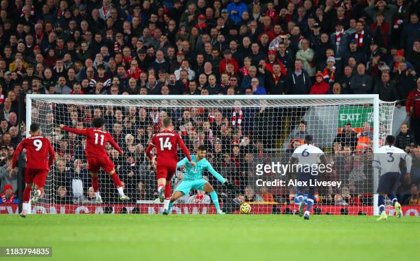 Mohamed Salah of Liverpool scores his team's second goal from a penalty past Paulo Gazzaniga of Tottenham Hotspur during the Premier League match...