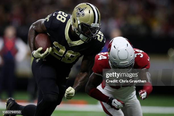 Latavius Murray of the New Orleans Saints runs for a touchdown against the Arizona Cardinals in the second quarter of their NFL game at Mercedes Benz...