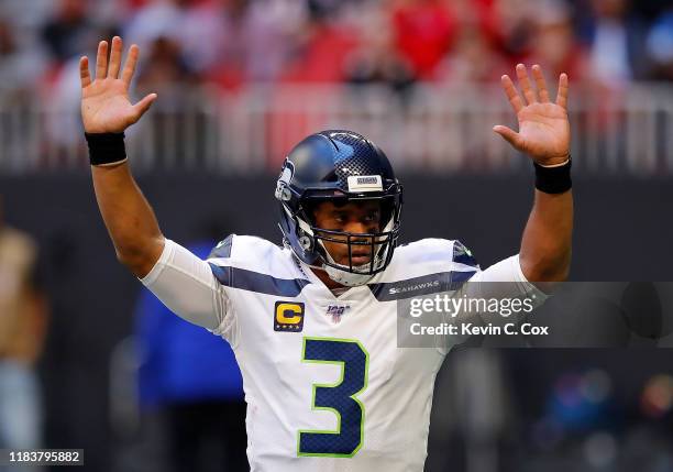 Russell Wilson of the Seattle Seahawks reacts after passing for a touchdown in the first half against the Atlanta Falcons at Mercedes-Benz Stadium on...