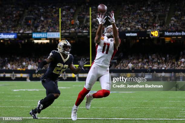 Larry Fitzgerald of the Arizona Cardinals attempts to catches the ball as Chauncey Gardner-Johnson of the New Orleans Saints defends during the first...