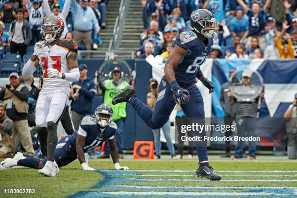 Jonnu Smith of the Tennessee Titans scores a touchdown against Carlton Davis of the Tampa Bay Buccaneers during the first half at Nissan Stadium on...