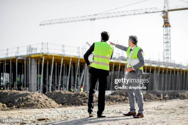 construction workers, supervisor, or engineer talk at job site - real estate developer stock pictures, royalty-free photos & images
