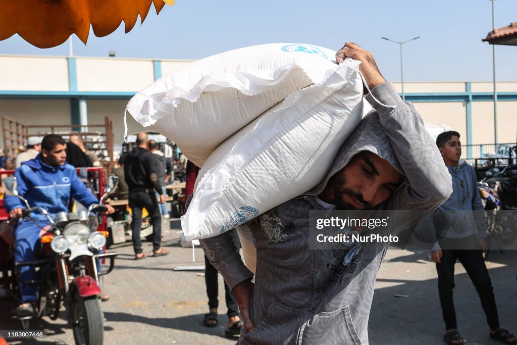 Palestinians Receive The Food At The Aid Distribution Centre Run By The UNRWA