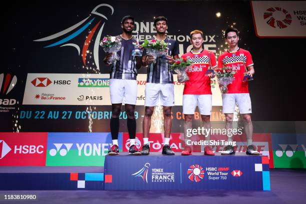 Satwiksairaj Rankireddy and Chirag Shetty of India and Marcus Fernaldi Gideon and Kevin Sanjaya Sukamuljo of Indonesia pose with their trophies after...