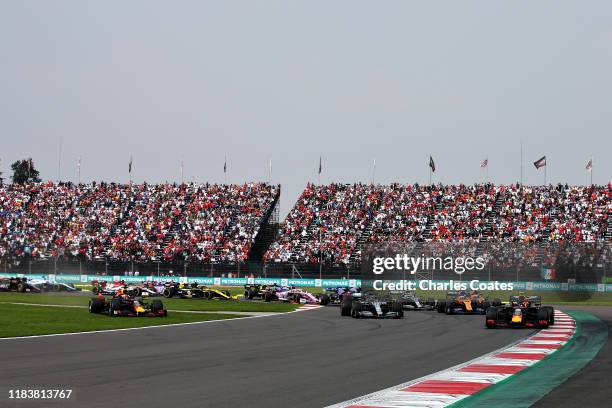 Alexander Albon of Thailand driving the Aston Martin Red Bull Racing RB15 leads Lewis Hamilton of Great Britain driving the Mercedes AMG Petronas F1...