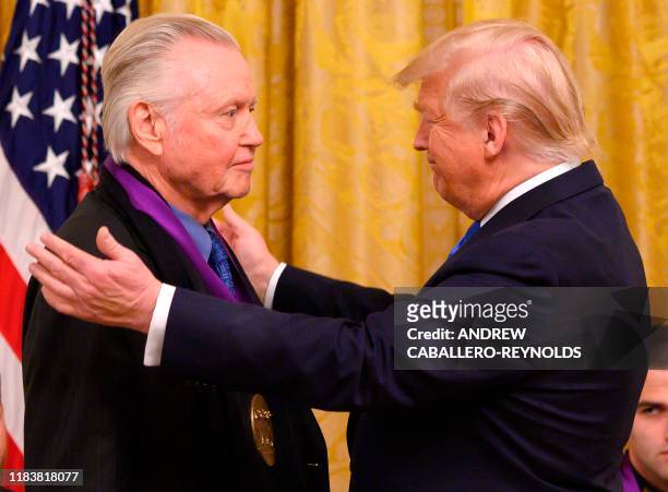 President Donald Trump awards the National Medal of Arts to actor Jon Voight in the East Room of the White House in Washington, DC, on November 21,...