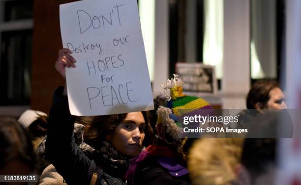 Protester holds a placard that says Don't destroy our hopes for peace during the protest. People gathered outside the Colombian embassy in the UK to...