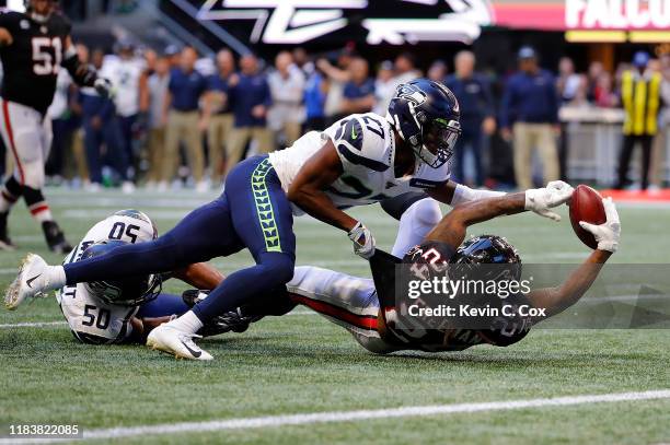 Devonta Freeman of the Atlanta Falcons fumbles the ball as he is tackled by Marquise Blair of the Seattle Seahawks in the second half at...