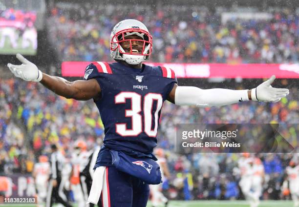 Cornerback Jason McCourty of the New England Patriots celebrates a touchdown in the first quarter of the game against the Cleveland Browns at...