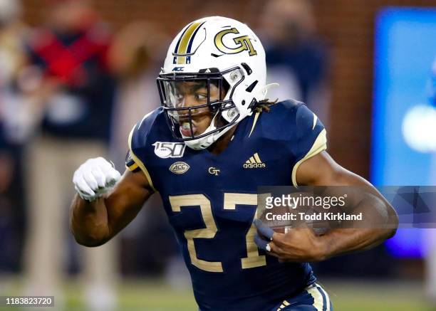 Jordan Mason of the Georgia Tech Yellow Jackets rushes during the first half against the North Carolina State Wolfpack at Bobby Dodd Stadium on...