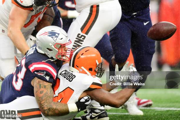 Running back Nick Chubb of the Cleveland Browns fumbles as he is hit by defensive tackle Lawrence Guy of the New England Patriots in the first...