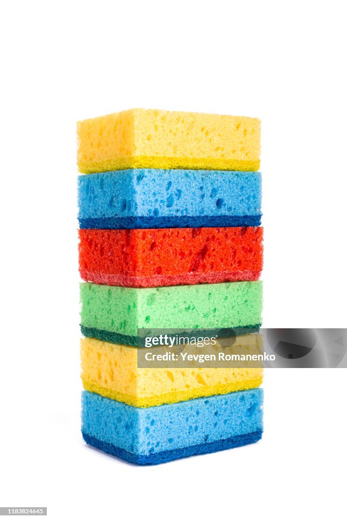 Stack of Brand new colourful sponges isolated on white background