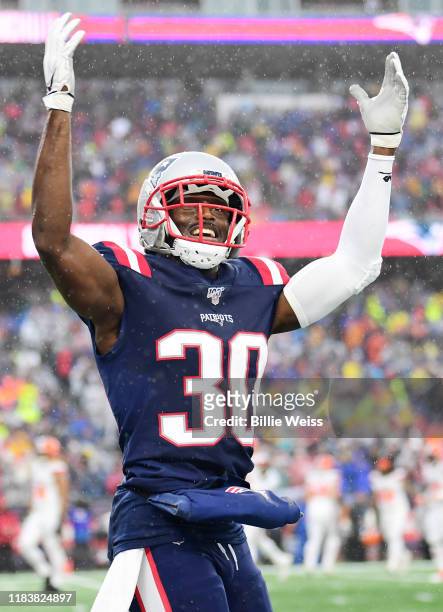 Cornerback Jason McCourty of the New England Patriots celebrates a touchdown in the first quarter of the game against the Cleveland Browns at...