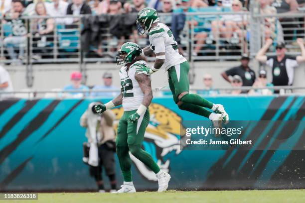 Leonard Williams of the New York Jets celebrates with his teammate Jamal Adams after making a defensive stop during the third quarter of a game...