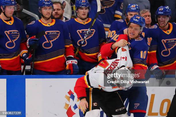 Brayden Schenn of the St. Louis Blues fights Rasmus Andersson of the Calgary Flames at Enterprise Center on November 21, 2019 in St Louis, Missouri.