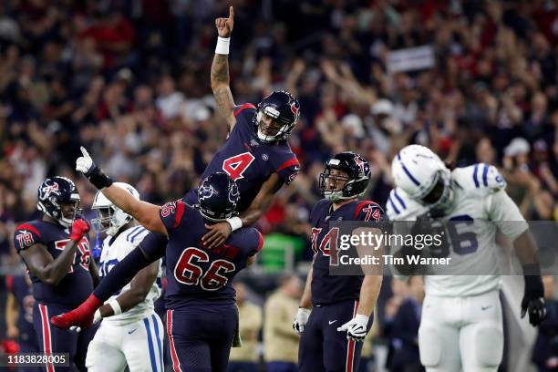 Nick Martin of the Houston Texans lifts Deshaun Watson in celebration after a fourth quarter touchdown pass against the Indianapolis Colts at NRG...