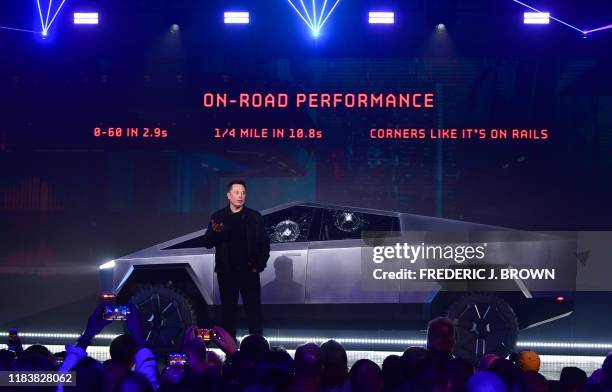 Tesla co-founder and CEO Elon Musk stands in front of the newly unveiled all-electric battery-powered Tesla's Cybertruck at Tesla Design Center in...