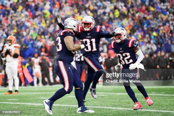 Defensive tackle Lawrence Guy of the New England Patriots celebrates an interception with teammates in the first quarter of the game against the...