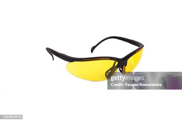 safety glasses with yellow lens isolated on white background - sunglasses ストックフォトと画像