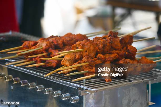 indian food chicken tikka over chargrill stove served at the 17th "diwali in yokohama" - chicken tandoori stock pictures, royalty-free photos & images