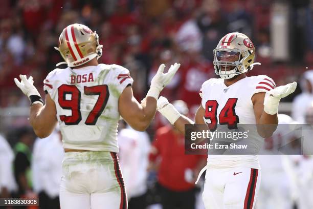 Nick Bosa and Solomon Thomas of the San Francisco 49ers react after sacking Kyle Allen of the Carolina Panthers during the second quarter at Levi's...