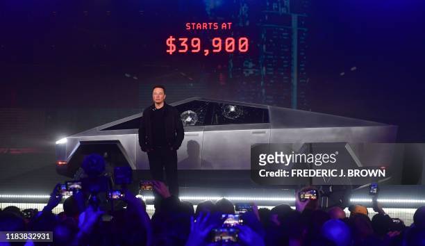 Tesla co-founder and CEO Elon Musk stands in front of the newly unveiled all-electric battery-powered Tesla's Cybertruck at Tesla Design Center in...