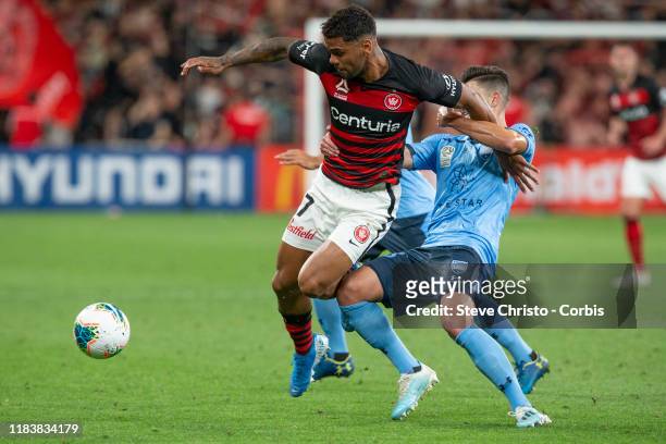 Kwame Yeboah of the Wanderers is tackled by Sydney's Paulo Retre during the round three A-League match between the Western Sydney Wanderers and...