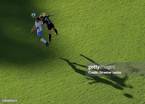 Sam Kerr of Chicago Red Stars goes up for a ball against McCall Zerboni of North Carolina Courage during the 2019 NWSL Championship game at WakeMed...