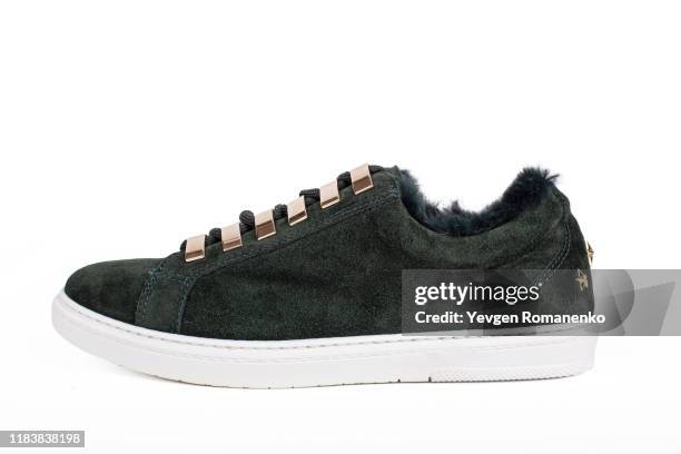 green suede low top sneakers with fur lining. isolated on white background - sole of shoe stock pictures, royalty-free photos & images