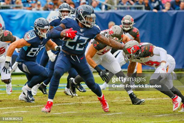 Derrick Henry of the Tennessee Titans stiff arms Andrew Adams of the Tampa Bay Buccaneers during the first half at Nissan Stadium on October 27, 2019...
