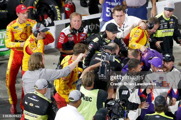 Denny Hamlin, driver of the FedEx Freight Toyota, Joey Logano, driver of the Shell Pennzoil Ford, and their crews have an altercation on pit lane...