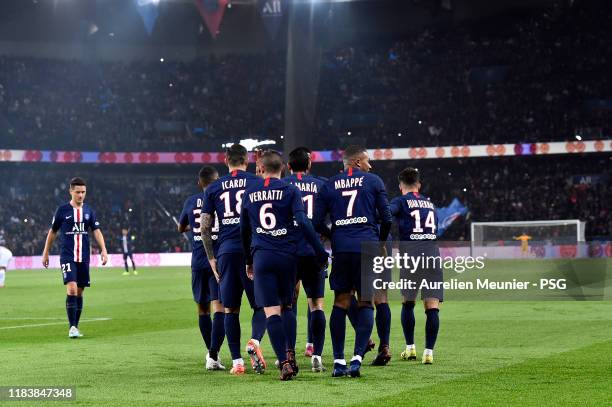 Kylian Mbappe of Paris Saint-Germain is congratulated by teammates after scoring during the Ligue 1 match between Paris Saint-Germain and Olympique...